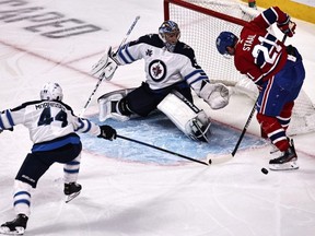 Jets goaltender Connor Hellebuyck and defenceman Josh Morrissey make sure that Canadiens forward Eric Staal isn’t able to score last night at the Bell Centre. USA TODAY Sports