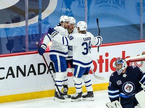 Toronto Maple Leafs forward John Taveres (91) is congratulated by teammates after scoring a goal against the Winnipeg Jets during the second period at Bell MTS Place on Saturday night.