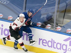 Maple Leafs' Morgan Rielly (right) battles along the boards with Ottawa Senators' Brady Tkachuk during the first period at Scotiabank Arena on Saturday, April 10.