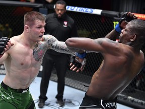 In this handout image provided by UFC, Marvin Vettori of Italy, left, punches Kevin Holland in a middleweight fight during the UFC Fight Night event at UFC APEX on April 10, 2021 in Las Vegas, Nevada.