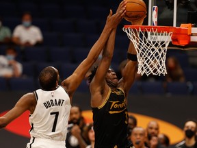 Toronto Raptors forward OG Anunoby dunks over Brooklyn Nets forward Kevin Durant on Tuesday.