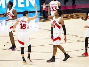 Yuta Watanabe of the Toronto Raptors high fives Freddie Gillespie.