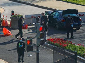 Law enforcement officers collect evidence at the site after a car rammed a police barricade outside the U.S. Capitol building on Capitol Hill in Washington, April 2, 2021.
