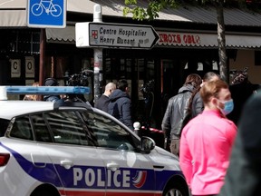 French police secure the area after one person was shot dead and one injured in front of the Henry Dunant hospital in Paris, France, April 12, 2021.