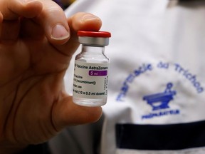 A pharmacist holds a vial of the AstraZeneca COVID-19 vaccine in a pharmacy in Roubaix as part of the coronavirus disease (COVID-19) vaccination campaign in France, March 15, 2021.