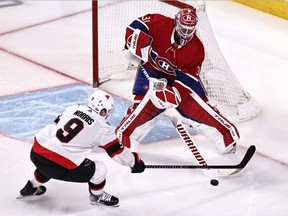 Canadiens goalie Carey Price clears the puck in front of Ottawa Senators centre Josh Norris during Saturday afternoon’s game at the Bell Centre.