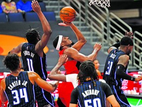 Raptors' Paul Watson puts up a shot against four Orlando Magic players, en route to a career-best 30 points on Friday, April 16, 2021, in Tampa, Fla.