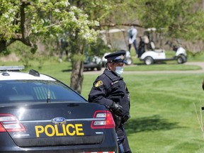 An Oxford OPP officer monitors golfers at The Bridges at Tillsonburg golf course on Saturday, May 1. OPP officers charged 19 golfers on Saturday and Sunday for playing on the course despite provincial emergency regulations requiring golf courses to close to slow the spread of COVID-19. The Bridges of Tillsonburg announced Tuesday that it is closing after the course was charged three times. (Chris Abbott/Tillsonburg News)