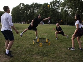 From the left:Thomas Prévost, Chris Stanford, Amadea Gareau and Effie Pomaki play in Jeanne-Mance park shortly before curfew on Wednesday.