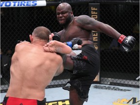 In this handout photo provided by UFC, (R-L) Derrick Lewis kicks Aleksei Oleinik of Russia in their heavyweight fight during the UFC Fight Night event at UFC APEX on August 08, 2020 in Las Vegas, Nevada.