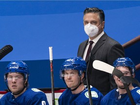 Head coach Travis Green of the Vancouver Canucks behind the bench.