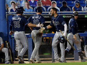 Tampa Bay Rays center fielder Kevin Kiermaier (39) celebrates with pinch runner Brett Phillips (35) after catcher Francisco Mejia (28) hit a grand slam in the twelfth inning against the Toronto Blue Jays on Friday.