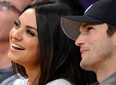 Actors Ashton Kutcher (R) and Mila Kunis sit courtside at the Los Angeles Lakers NBA match up against the Phoenix Suns Los Angeles February 12, 2013.