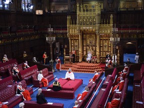 Queen Elizabeth reads the Queen's Speech on the Sovereign's Throne in the House of Lords chamber during the State Opening of Parliament at the Houses of Parliament in London on May 11, 2021.