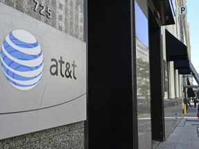 In this file photo an AT&T telecommunication logo is seen at the entrance of a building in Washington, D.C., June 11, 2019.