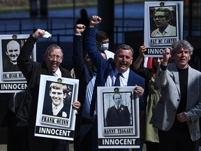 Family members of the victims gesture as they pose for a picture after listening to the findings of the report on the fatal shootings of 10 people in the Ballymurphy area of Belfast in 1971 that involved the British Army, in Belfast, Northern Ireland, May 11, 2021.