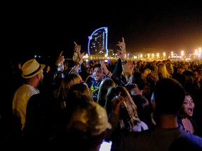 People dance at the Barceloneta beach, as the state of emergency decreed by the Spanish Government to prevent the spread of COVID-19 was lifted a week ago in Barcelona, Spain, May 16, 2021.