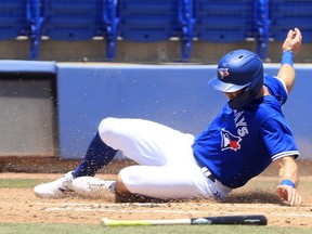 Randal Grichuk of the Toronto Blue Jays slides safely into home plate following a single by Danny Jansen during a game against the Atlanta Braves at TD Ballpark on May 2, 2021 in Dunedin, Florida.