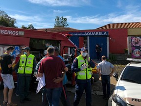 Photo released by Brazilian newspaper Imprensa do Povo showing people and local authorities at the surroundings of the Aquarela Daycare School in Saudades, Brazil, on May 4, 20121.