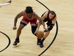 Raptors' Malachi Flynn (right) and Bulls' Coby White battle for a loose ball during the second half at United Center in Chicago on Thursday, May 13, 2021.