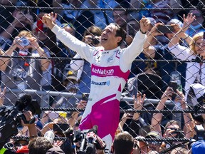 Helio Castroneves celebrates after winning the Indianapolis 500 at Indianapolis Motor Speedway Sunday.