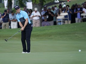 Jordan Spieth watches his putt on the eighteenth green for an eagle during the first round of the AT&T Byron Nelson golf tournament in McKinney, Texas, May 13, 2021.