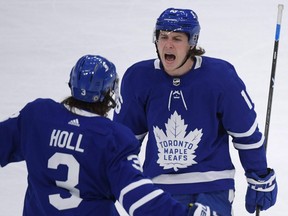 Maple Leafs forward Mitch Marner (right) celebrates with defenceman Justin Holl after scoring a goal against the Canadiens in the second period at Scotiabank Arena in Toronto, Saturday, May 8, 2021.
