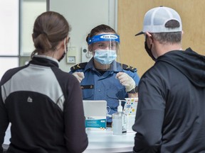 Sailor Second Class Hannah Angel directs residents as they arrive for asymptomatic COVID-19 testing at the Canada Games Centre in Halifax on Wednesday, April 28, 2021.