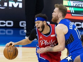 Philadelphia 76ers guard Seth Curry, left, drives against Orlando Magic forward Ignas Brazdeikis during the second quarter at Wells Fargo Center in Philadelphia, May 14, 2021.