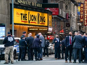 Police officers are seen in New York City's Times Square following a shooting that injured three people, Saturday, May 8, 2021.