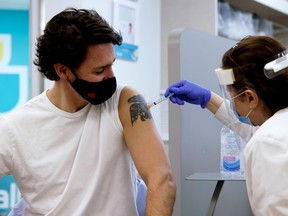 FILE PHOTO: Canada's Prime Minister Justin Trudeau is inoculated with AstraZeneca's vaccine against coronavirus disease (COVID-19) at a pharmacy in Ottawa, Ontario, Canada April 23, 2021.   REUTERS/Blair Gable/File Photo ORG XMIT: FW1