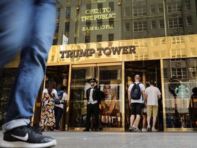 People walk by Trump Tower on Fifth Avenue in Manhattan, N.Y., on Aug. 24, 2018.