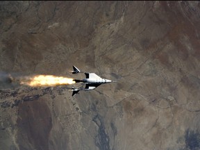 Virgin Galactic's VSS Unity, piloted by CJ Sturckow and Dave Mackay, starts its engines after release from its mothership, VMS Eve, on the way to its first spaceflight after launch from Spaceport America, N.M., May 22, 2021 in a still image from video.