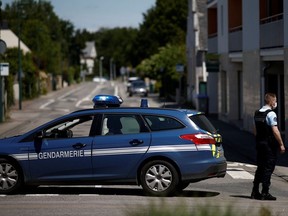 French gendarmes secure the area after an assailant stabbed and badly wounded a policewoman in La Chapelle-sur-Erdre, western France, May 28, 2021.