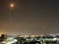 A streak of light is seen as Israel's Iron Dome anti-missile system intercepts rockets launched from the Gaza Strip towards Israel, as seen from Ashkelon, Israel May 11, 2021.