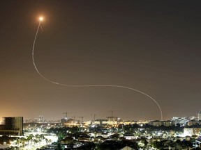 A streak of light is seen as Israel's Iron Dome anti-missile system intercepts rockets launched from the Gaza Strip towards Israel, as seen from Ashkelon, Israel May 11, 2021.
