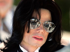 In this June 13, 2005 photo, Michael Jackson gestures as he leaves court during his trial on child molestation charges in Santa Maria, Calif.