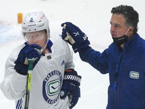 Defenceman Jack Rathbone gets training camp directives from Canucks coach Travis Green.