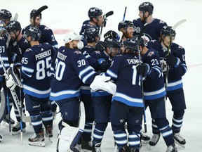 Winnipeg Jets forward Nikolaj Ehlers is mobbed after scoring an overtime goal against the Edmonton Oilers in Game 3 of a Stanley Cup playoff series in Winnipeg on Sunday, May 23, 2021.