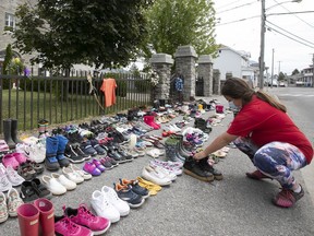 Aianano Ronon was one of many who placed shoes in front of St. Francis Xavier Mission Catholic Church in Kahnawake over the weekend, to honour the 215 children whose remains were found on the former site of a residential school in Kamloops, B.C.