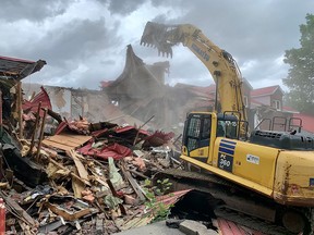 A payloader demolishes the former Hells Angels bunker in Sherbrooke on June 30, 2021.