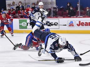 Winnipeg Jets' Blake Wheeler falls to the ice against the Montreal Canadiens on Sunday night.