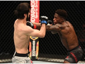 ABU DHABI, UNITED ARAB EMIRATES - SEPTEMBER 27: In this handout image provided by UFC, (R-L) Hakeem Dawodu of Canada punches Zubaira Tukhugov of Russia in their featherweight bout during UFC 253 inside Flash Forum on UFC Fight Island on September 27, 2020 in Abu Dhabi, United Arab Emirates.