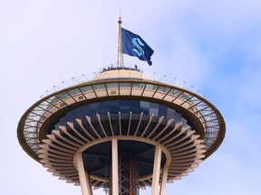 A general view of the Space Needle as the Seattle Kraken team flag is hung from above on July 23, 2020 in Seattle, Washington.