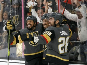 Ryan Reaves (75), Keegan Kolesar (55) and William Carrier (28) of the Vegas Golden Knights celebrate against the Colorado Avalanche in Game 6 of their second-round 2021 Stanley Cup Playoffs at T-Mobile Arena on June 10, 2021, in Las Vegas.
