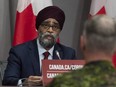 Chief of Defence Staff Jonathan Vance, right, looks on as National Defence Minister Harjit Sajjan makes opening remarks at a news conference in Ottawa on June 26, 2020.