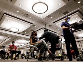 Simran Kaur receives a COVID-19 vaccine inside the International Conference Centre during Peel Region's "Doses After Dark" overnight Covid-19 vaccination clinic in Mississauga on May 15, 2021.