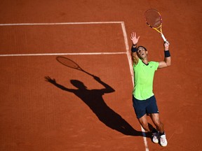 Spain's Rafael Nadal returns the ball to Italy's Jannik Sinner during their men's singles fourth round tennis match at Court Suzanne Lenglen on Day 9 of The Roland Garros 2021 French Open tennis tournament in Paris on June 7, 2021.
