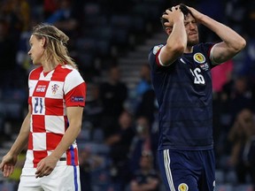 Scotland's defender Scott McKenna (R) reacts during the UEFA EURO 2020 Group D football match between Croatia and Scotland at Hampden Park in Glasgow on June 22, 2021.
