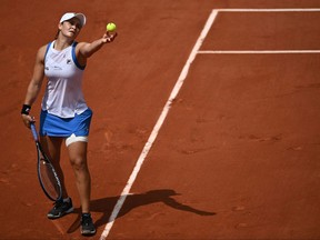 Australia's Ashleigh Barty serves the ball to Poland's Magda Linette during their women's singles second round tennis match on Day 5 of The Roland Garros 2021 French Open tennis tournament in Paris on June 3, 2021.